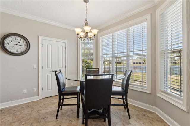 dining room with an inviting chandelier, plenty of natural light, ornamental molding, and baseboards