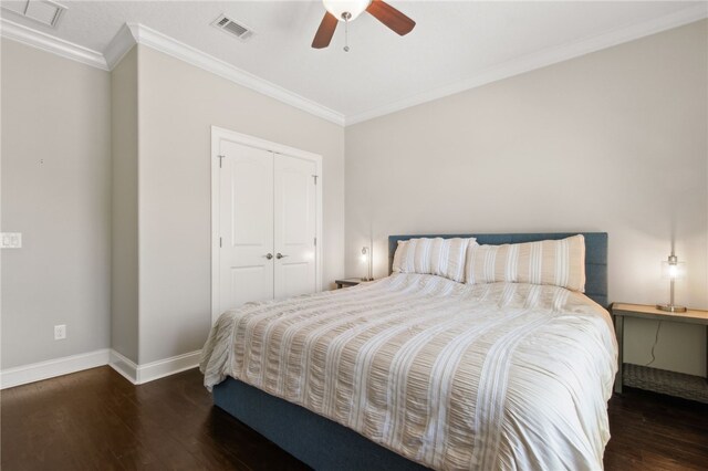 bedroom featuring crown molding, baseboards, visible vents, a closet, and wood finished floors