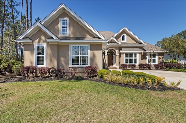 craftsman house with a front yard and stucco siding