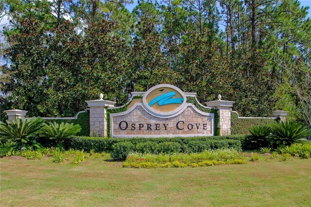 community sign featuring a lawn