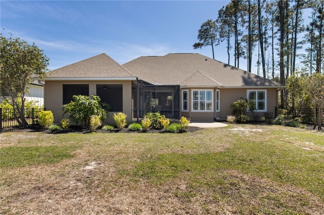 back of property with fence, a patio, stucco siding, a shingled roof, and a yard