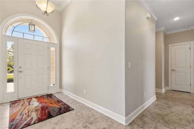 foyer entrance featuring baseboards, ornamental molding, and recessed lighting