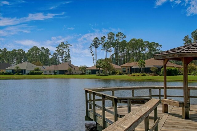 dock area featuring a water view and a residential view