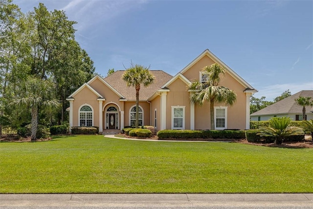 17 Willow Ct, Brunswick, GA 31523 - mediterranean / spanish-style home with stucco siding and a front lawn
