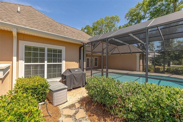 17 Willow Ct, Brunswick, GA 31523 - outdoor pool featuring grilling area, a patio area, and glass enclosure