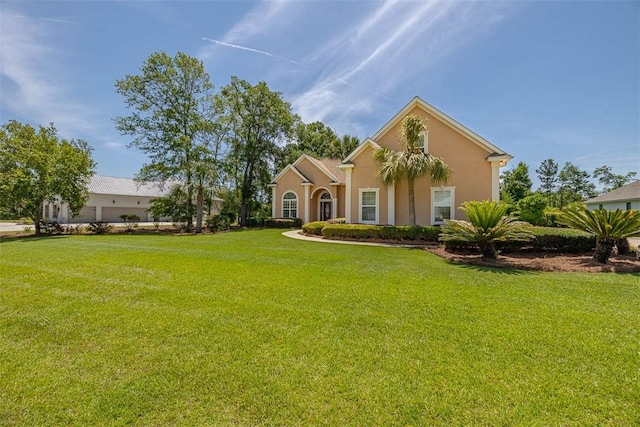 17 Willow Ct, Brunswick, GA 31523 - view of front of house with a front yard and stucco siding