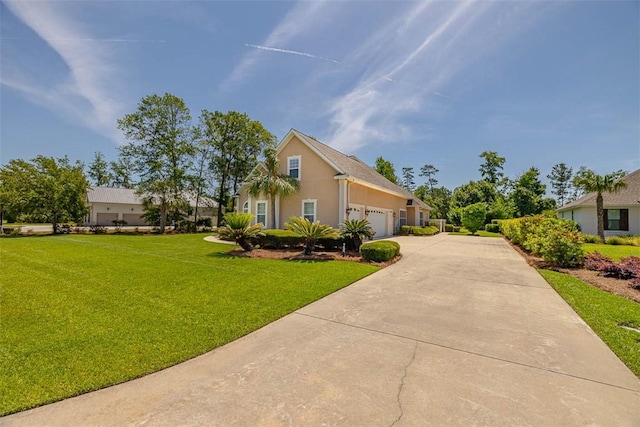 17 Willow Ct, Brunswick, GA 31523 - view of front of home with concrete driveway, a front yard, a garage, and stucco siding