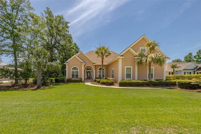 17 Willow Ct, Brunswick, GA 31523 - mediterranean / spanish house featuring stucco siding and a front lawn