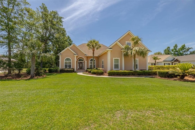 17 Willow Ct, Brunswick, GA 31523 - mediterranean / spanish-style house featuring a front lawn and stucco siding