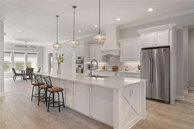 107 Cason Noah Dr, Kingsland, GA 31548 - kitchen with pendant lighting, premium range hood, sink, a large island, and stainless steel appliances