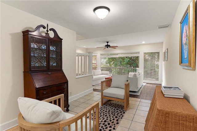 sitting room with ceiling fan and light tile patterned floors