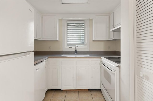 kitchen with light tile patterned floors, white appliances, white cabinetry, and sink