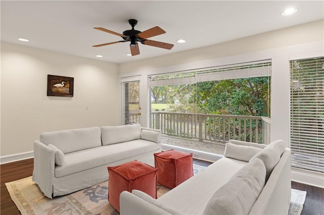 living room with dark hardwood / wood-style floors and ceiling fan