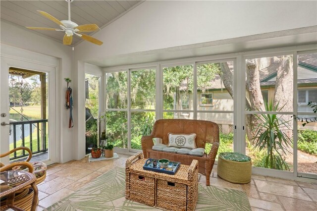 sunroom / solarium with a healthy amount of sunlight, ceiling fan, and lofted ceiling