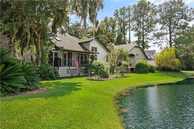 exterior space with a water view and a front yard