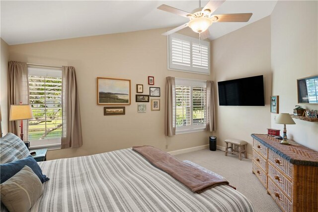 bedroom featuring light colored carpet, high vaulted ceiling, multiple windows, and ceiling fan