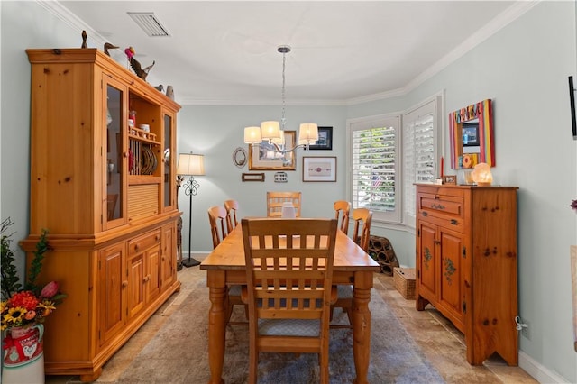 dining area featuring crown molding and an inviting chandelier