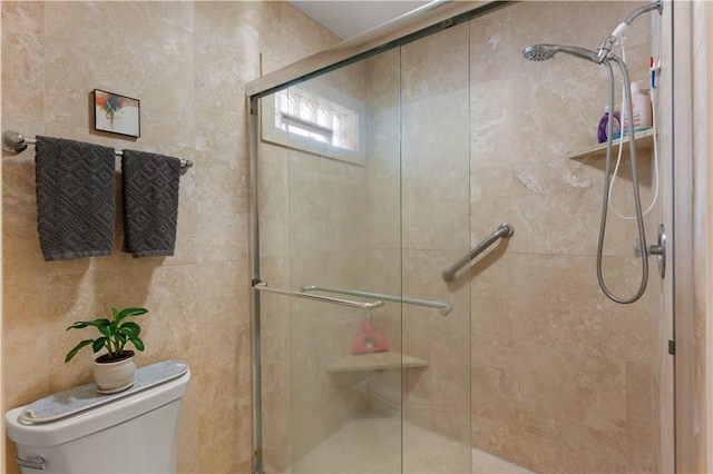 bathroom featuring walk in shower and toilet