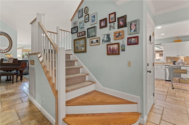 stairs featuring crown molding