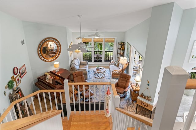 living room with hardwood / wood-style flooring and ceiling fan