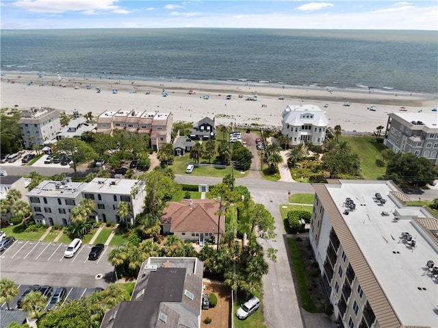 birds eye view of property with a beach view and a water view