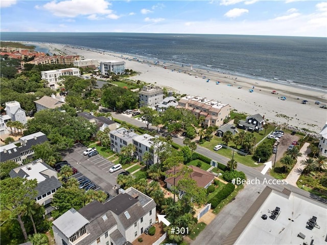 bird's eye view with a water view and a beach view