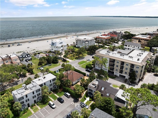 bird's eye view featuring a water view and a beach view