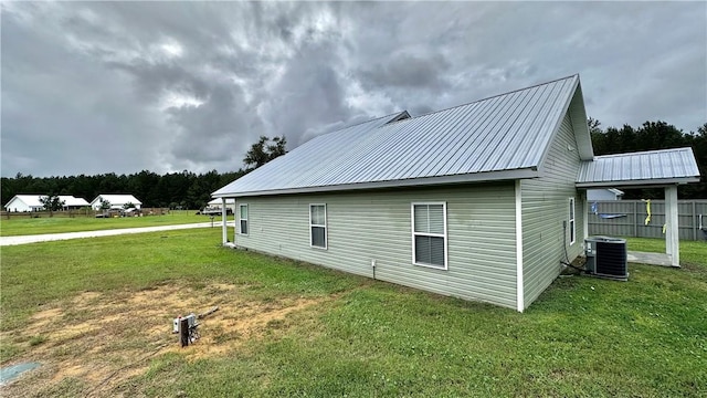 view of property exterior featuring a lawn and central AC unit