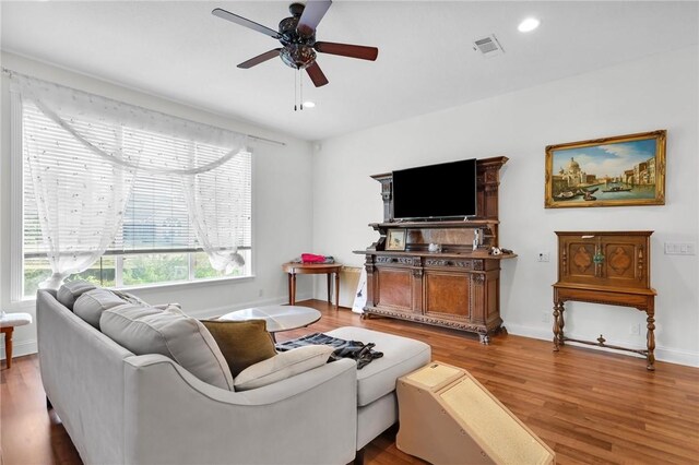 living room featuring baseboards, visible vents, a ceiling fan, wood finished floors, and recessed lighting