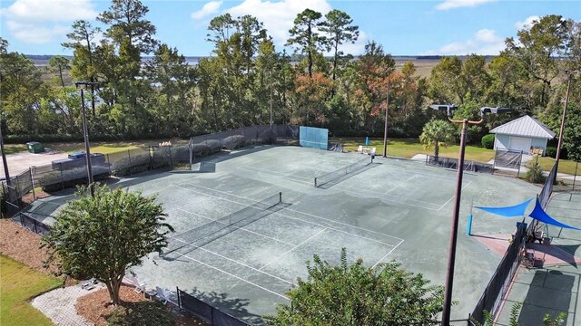 view of tennis court featuring fence