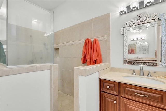 full bath featuring walk in shower and vanity