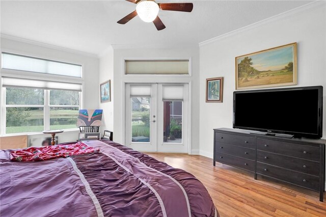 bedroom featuring access to outside, french doors, crown molding, and wood finished floors