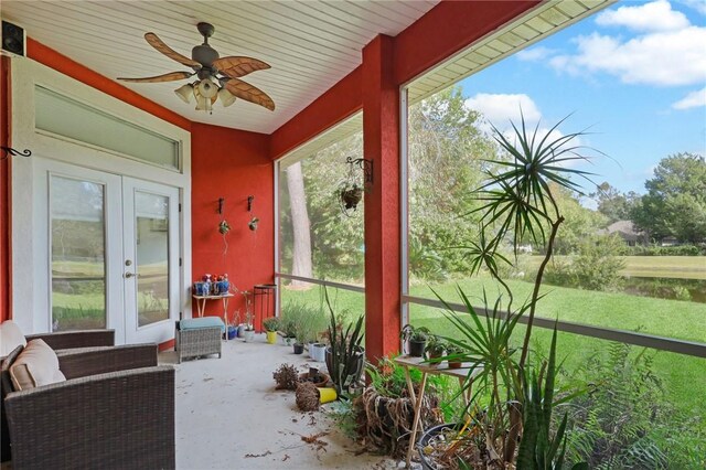 sunroom with a ceiling fan and french doors