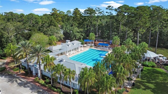 community pool with a patio area and a yard