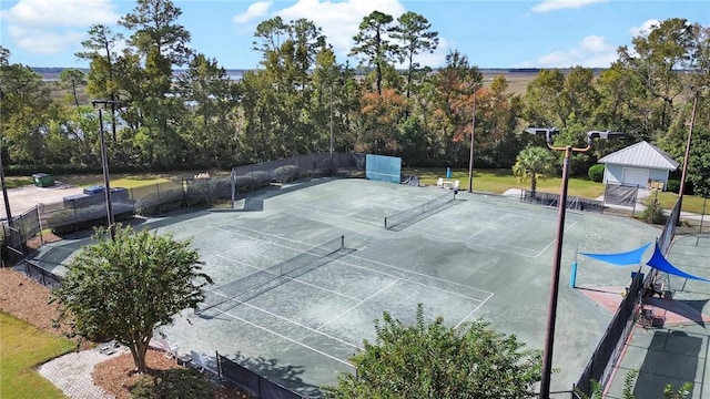 view of tennis court with fence