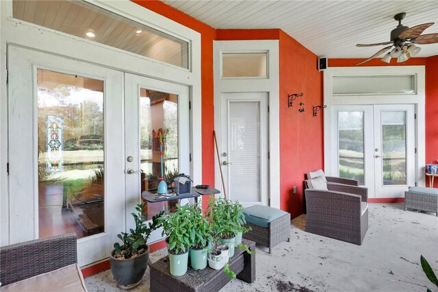 view of exterior entry with a ceiling fan and french doors