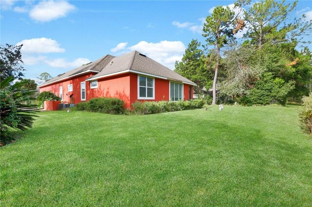 view of side of property featuring a lawn