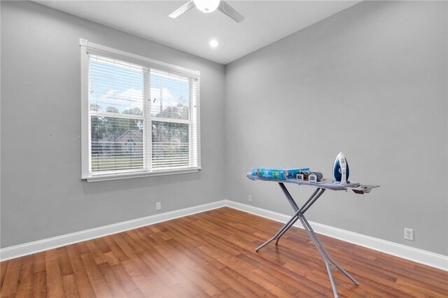 interior space featuring ceiling fan, baseboards, wood finished floors, and recessed lighting