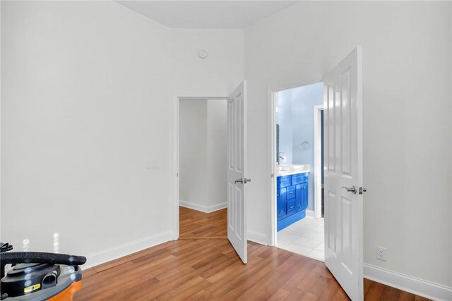 bedroom featuring baseboards and light wood-style floors