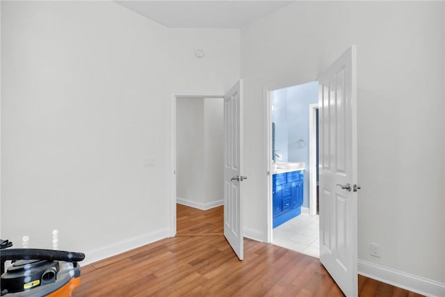 bedroom with light wood-type flooring and baseboards