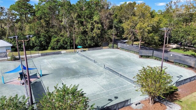 view of sport court featuring fence