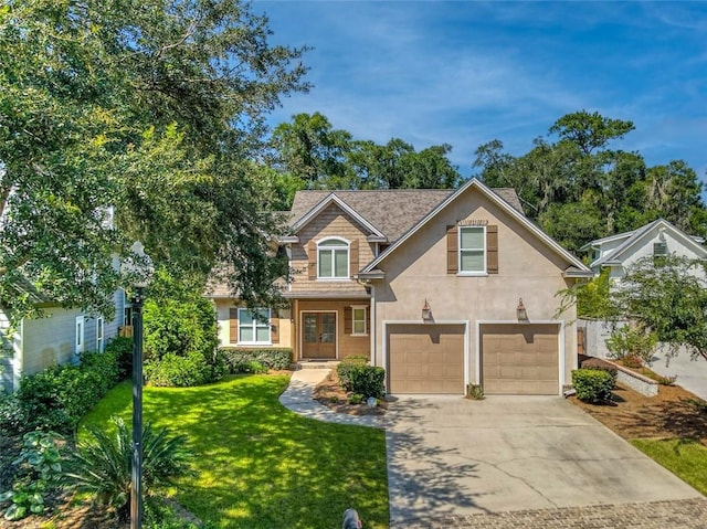 view of property featuring a front yard and a garage