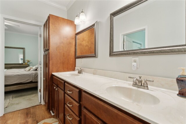 40 Jada Ln, Brunswick, GA 31523 - ensuite bathroom featuring crown molding, double vanity, and wood finished floors