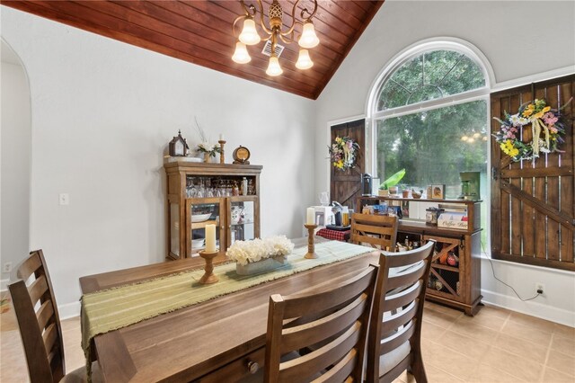 40 Jada Ln, Brunswick, GA 31523 - dining room with vaulted ceiling, wooden ceiling, light tile patterned flooring, arched walkways, and a chandelier