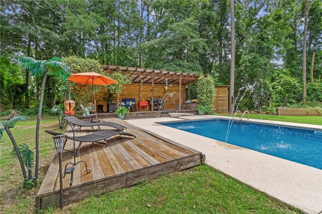 40 Jada Ln, Brunswick, GA 31523 - outdoor pool featuring a deck, view of wooded area, and a yard