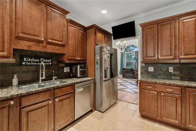 40 Jada Ln, Brunswick, GA 31523 - kitchen featuring stainless steel appliances, a sink, backsplash, stone counters, and ornamental molding