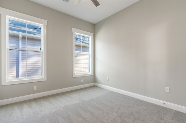 carpeted spare room with baseboards, ceiling fan, and vaulted ceiling