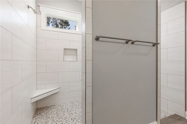 full bath with a tile shower