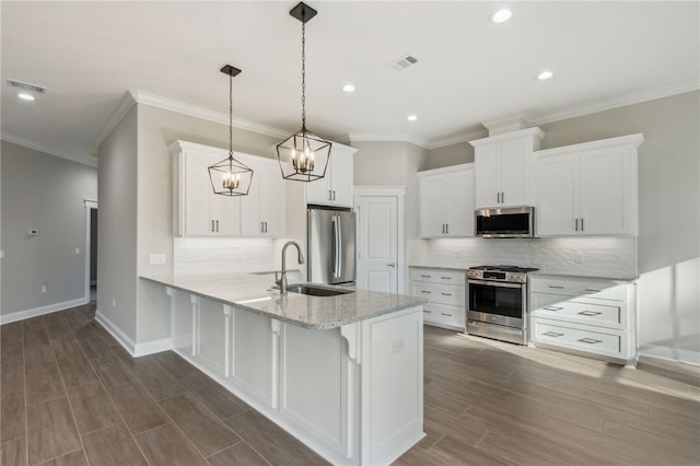 kitchen with stainless steel appliances, baseboards, a peninsula, and white cabinets