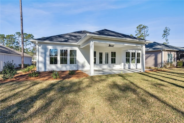 rear view of property with a yard, a patio, and a ceiling fan